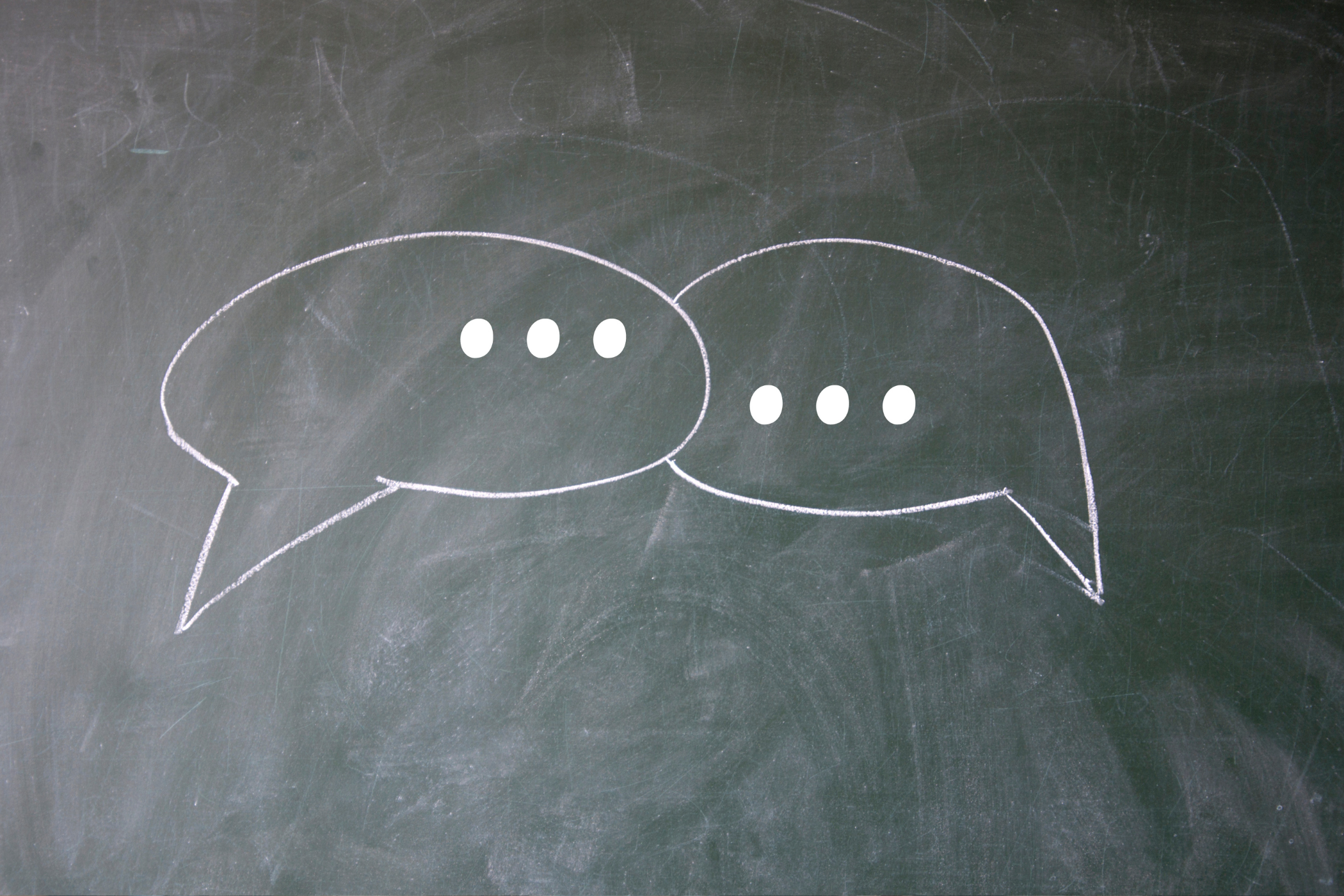 Two speech bubbles with no words, as two people aren't communicating